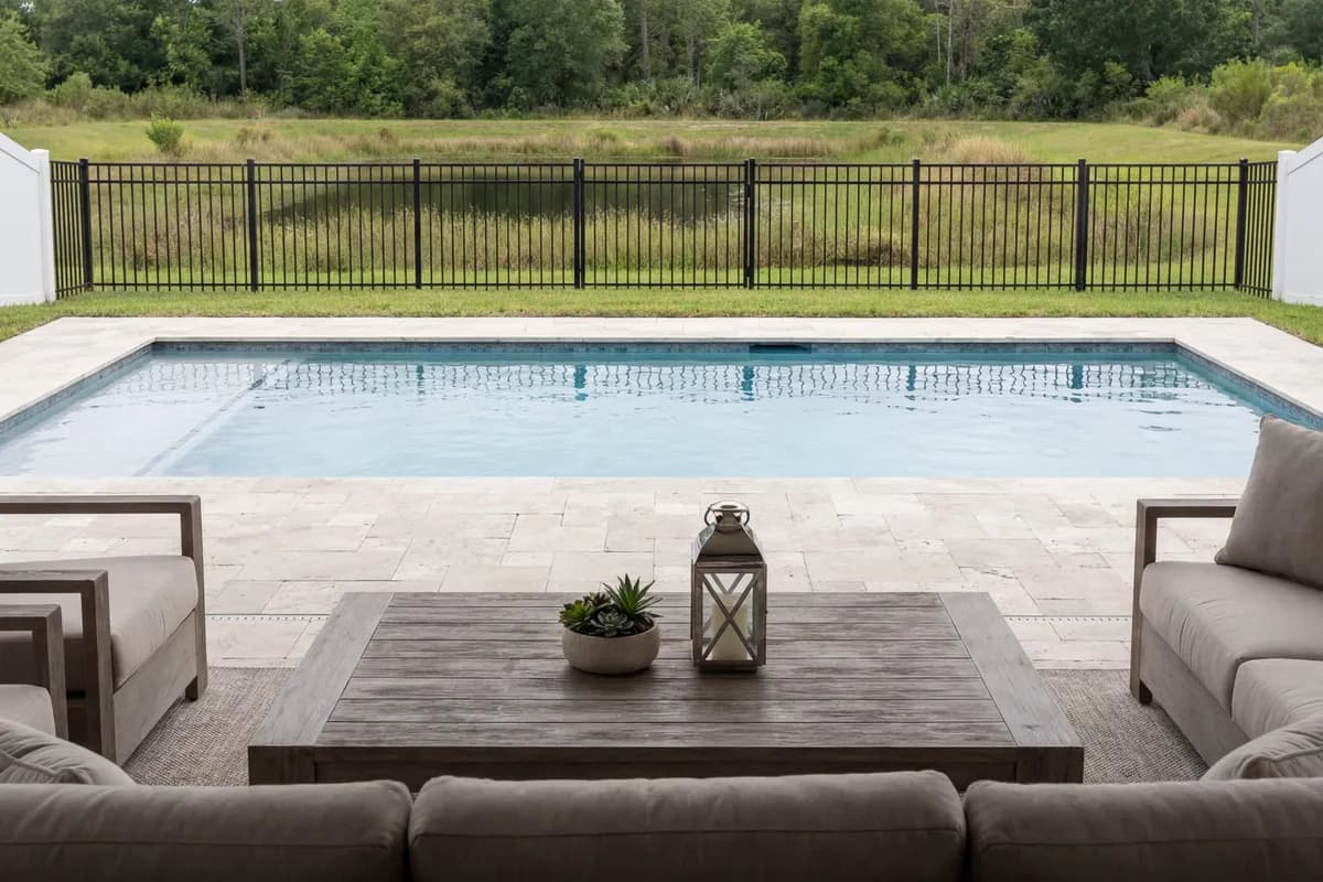 White vinyl privacy fence beside a swimming pool